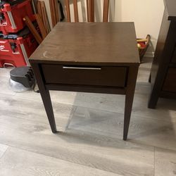 Brown wooden side table with drawer