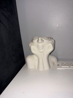 Porcelain art statue.( Candle size) great piece to add to a room.