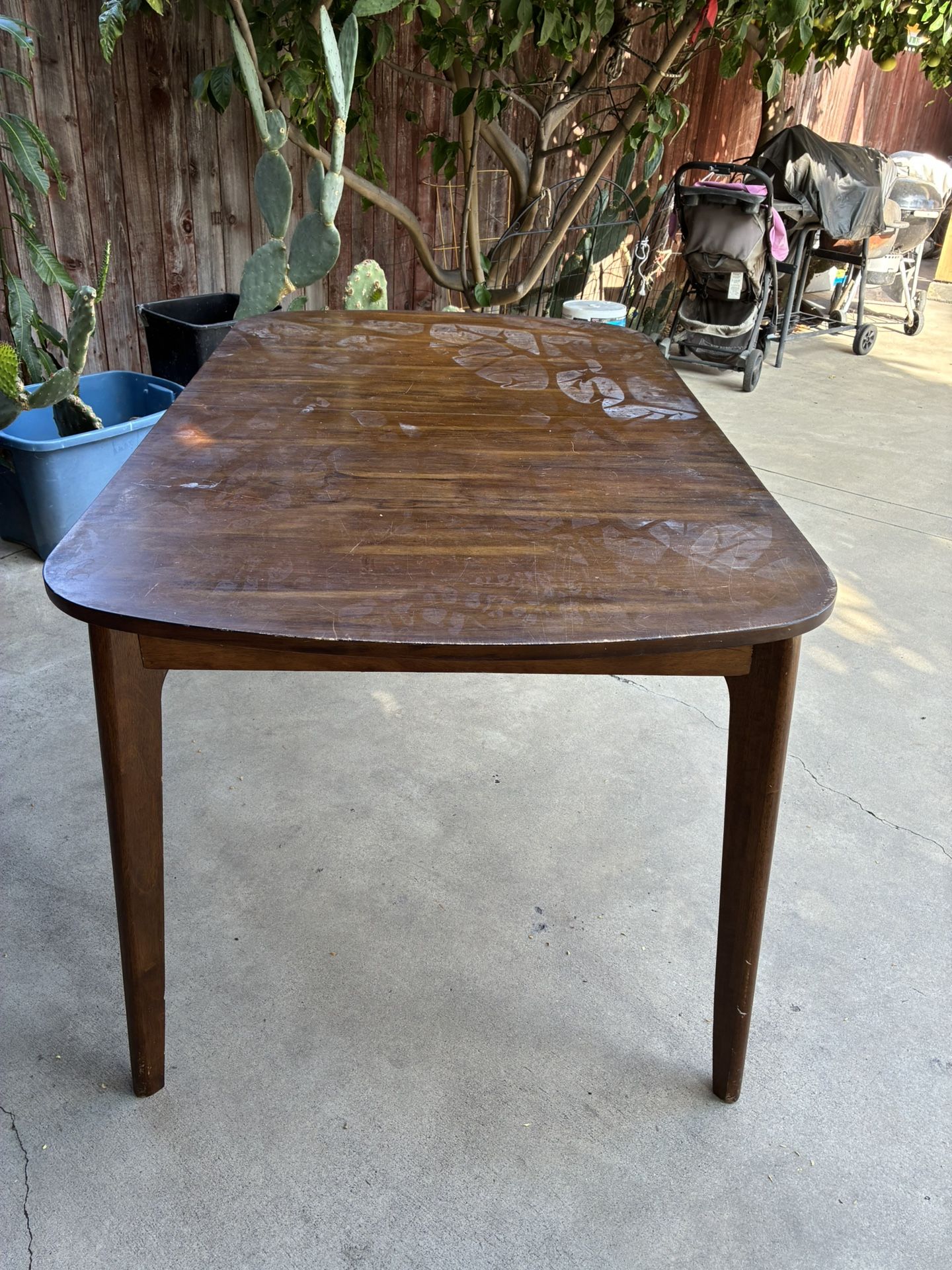 Antique dining table (possible a Mid-Century Modern?) It needs some refinishing , Extendable Leaf missing. 60” x 36” x 30” H