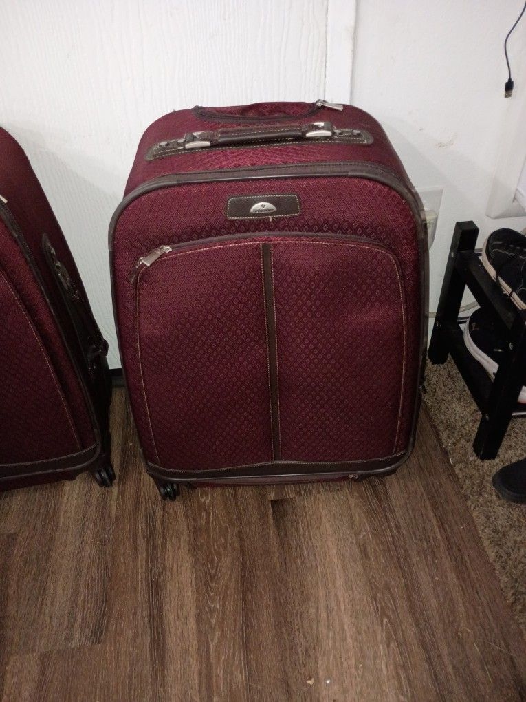 2 Almost New Samsonite Roll And Turn Suitcases
