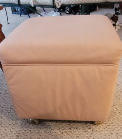 Soft leather beige ottoman on wheels