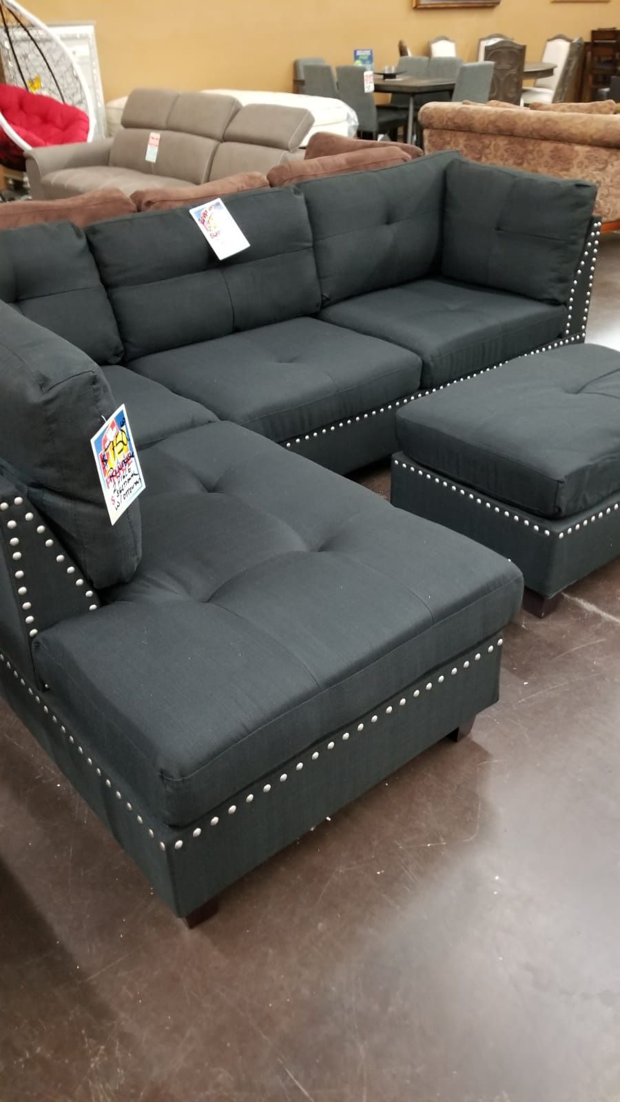 Traditional Black pinhead reversible sectional with a matching ottoman