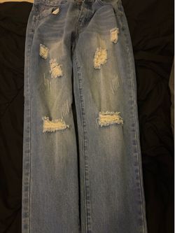 Blue distressed denim jeans wi the rips