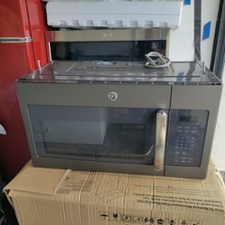 like new GE slate microwave oven with the bracket and a warranty