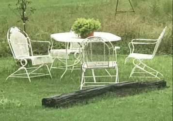 Vintage wrought iron mesh, large oval matching table and 4 coil spring rocker chairs, in good condition, for $200