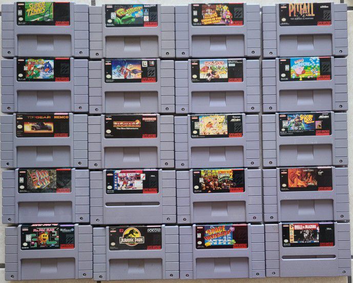 Super Nintendo (SNES) games lot of 20 with 2 controllers.