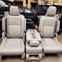 TAN LEATHER BUCKET SEATS WITH SEATBELTS AND MIDDLE SEAT 