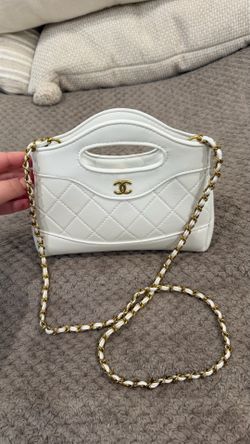 White designer bag with gold hardware
