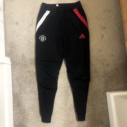 Black sweatpants/joggers with red and white logos on the side 