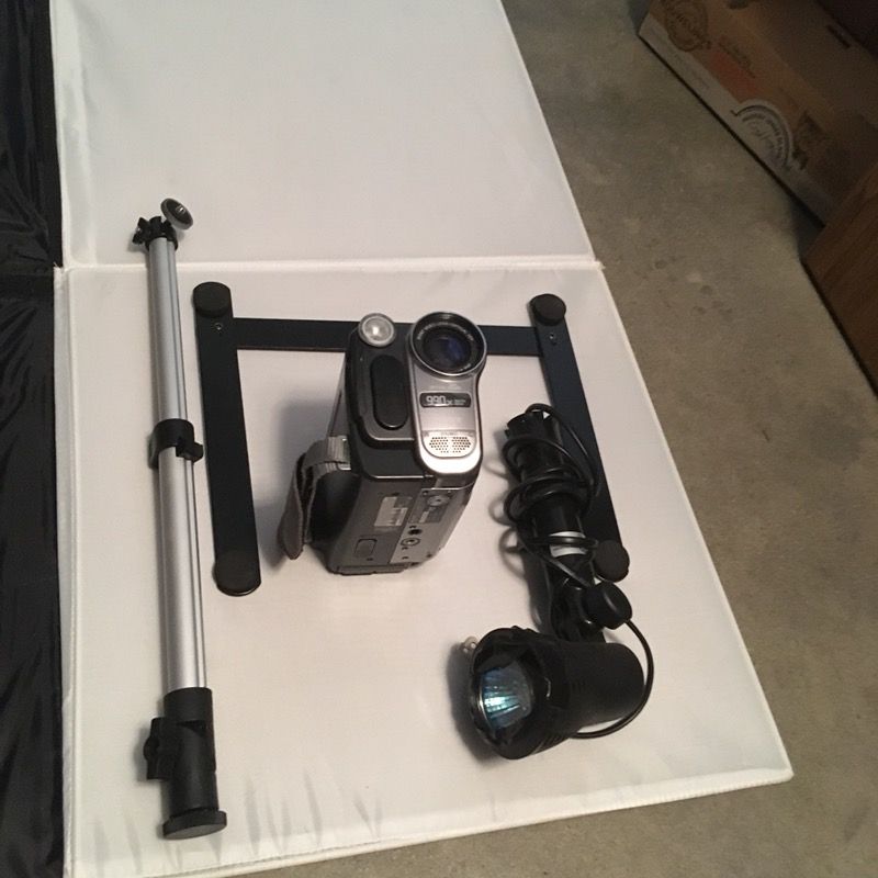 Camera equipment with lighting backdrop tripod