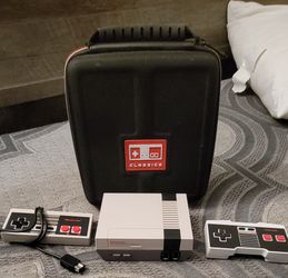 NINTENDO NES WITH 2 REMOTES AND A CASE