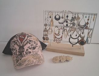 A Gal's "extra" earrings. nail polish and ballcap