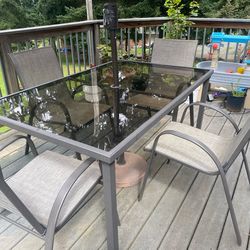 Outdoor table, chairs and umbrella