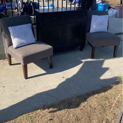 2 Comfortable Dinning Chairs And A Black Hallway Cabinet 