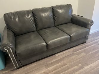 Like New - Faux Leather Sofa - Pull Out Bed Full Size Mattress - ( Ashley Furniture )