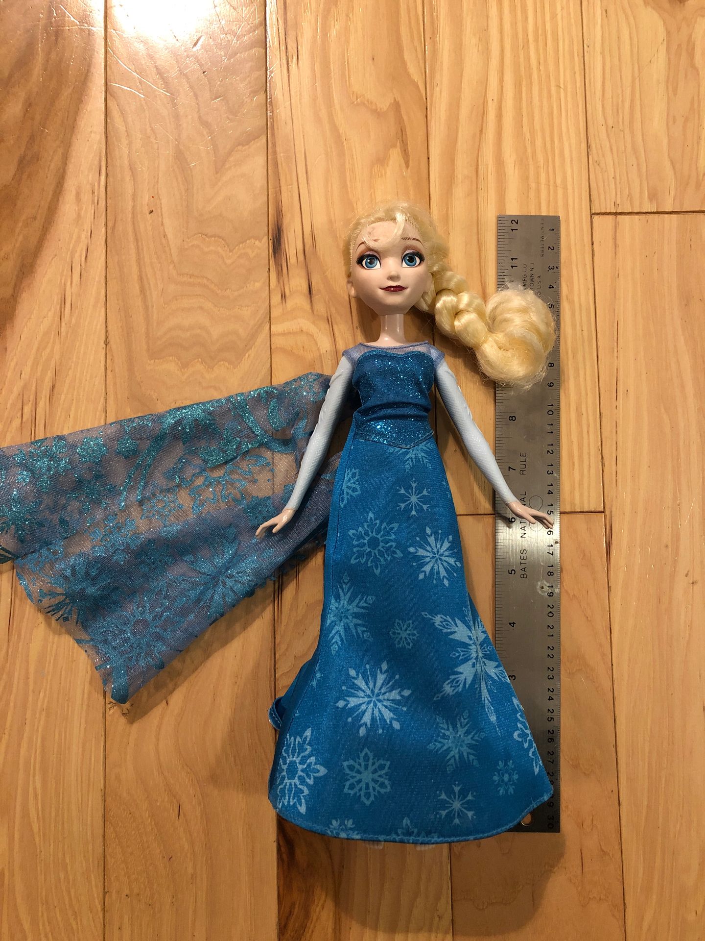LIKE NEW 12” Light-up Musical Frozen Elsa Doll - Flashing snowflakes, sings, but the most important part is the on/off switch. (You’re welcome.)