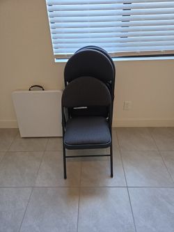 4 gently used padded folding chairs