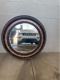 Ornate oval bronze mirror