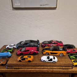 Assorted toy cars in various colors and models.
14 pieces