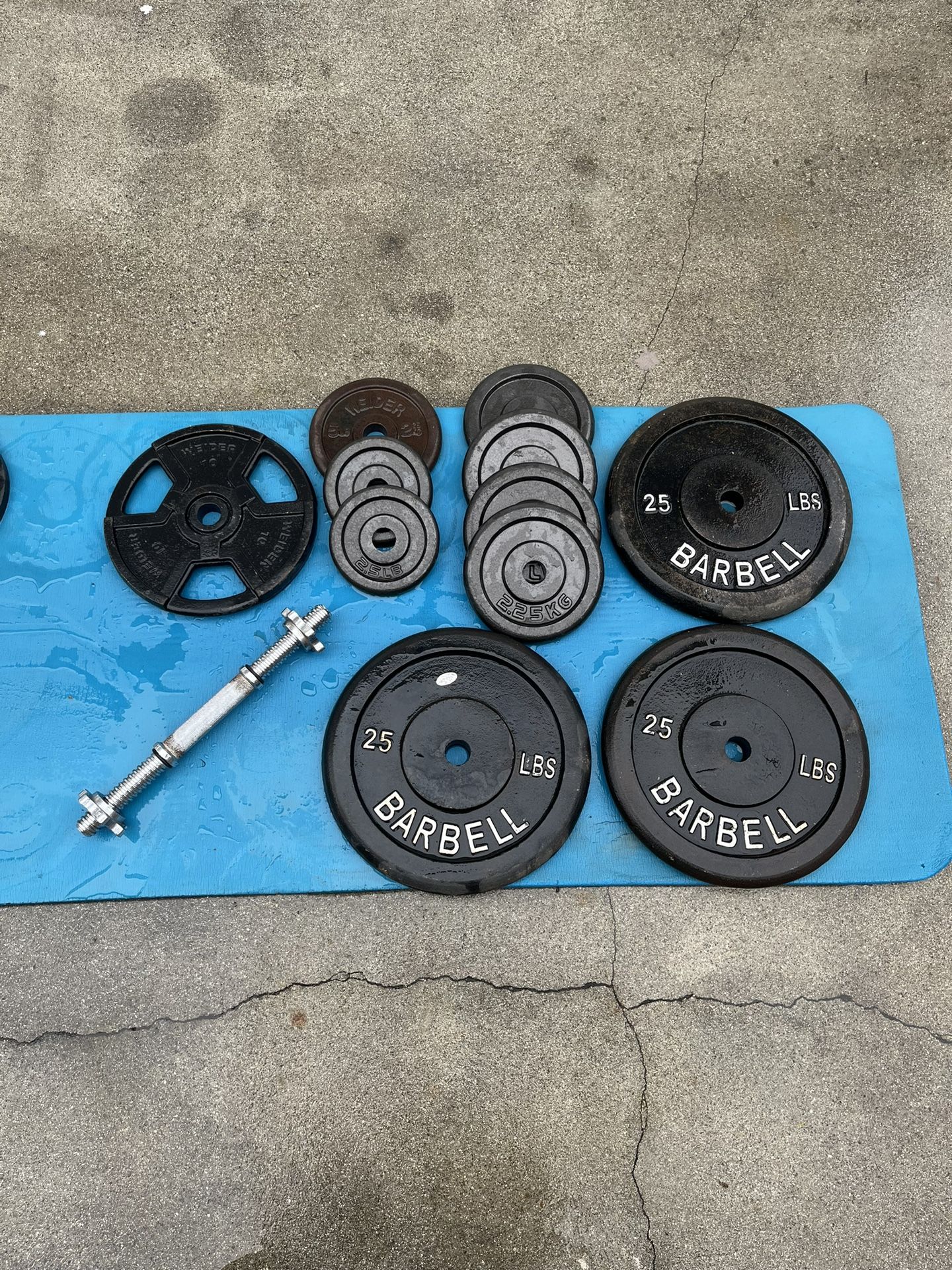Dumbbell Set One 25 LB Dumbbell And One 10 Pound Plate And 3 25 Pound Plates
