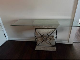 Modern glass console table with matching wall decor