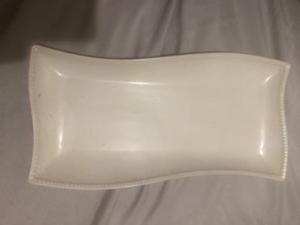 Elegant white serving platter with a wavy design
