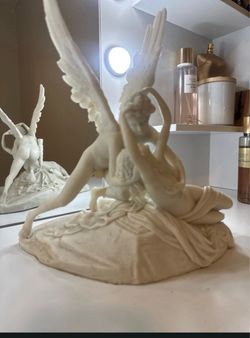 Psyche Revived by Cupid's Kiss" white marble-style statue manufactured by Pacific Giftware.