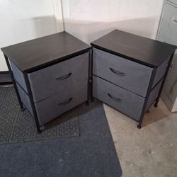 two-drawer fabric storage nightstand with a dark wood top and black metal frame.