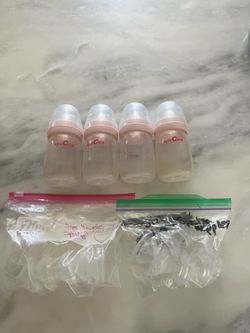 4 Spectra baby bottles with various size nipples
