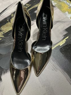 Calvin Klein Hayden d'Orsay pumps in a gold mirror metallic or patent finish.