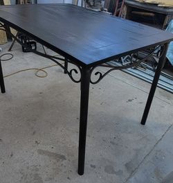 Sleek Black Dining Table with Wrought Iron Underframe