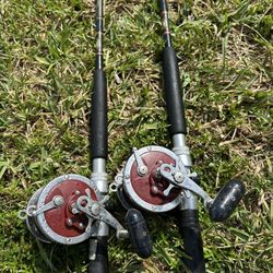 Pair Of PENN Senator 113H conventional fishing reel mounted on a fishing rod. 