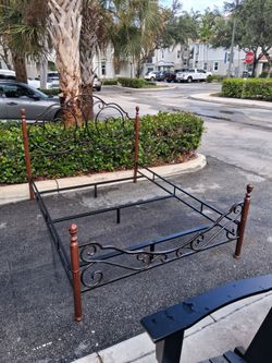 Wesson Home Adison Queen Bed Frame Features Ornate Bronze Scrolls and Cherry wood finish posts