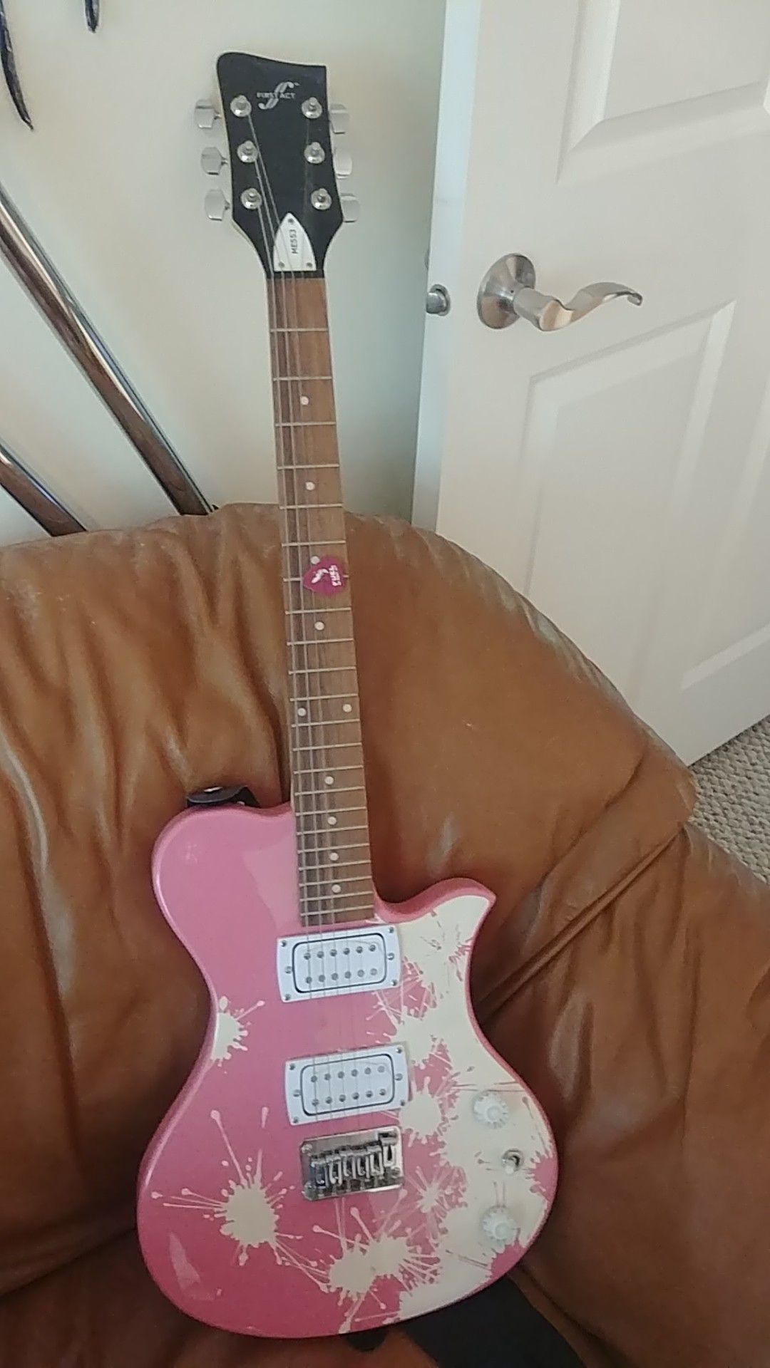 First act pink and white electric guitar