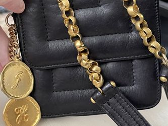 Mini Crossbody with gold charms and gold chains hold your credit card some cash and a phone that’s it