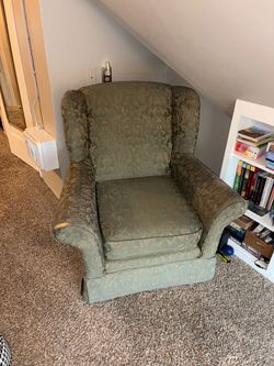 Green cozy wingback armchair