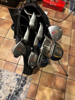 Wilson golf bag with clubs and shoes