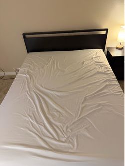 Queen mattress with bed frame and nightstand