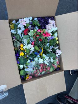 New open box full of artificial flower bunches