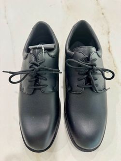 A pair of none-slip black shoes from Shoes For Crews.