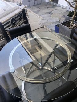 Glass round table kitchen set with leather high chairs.