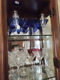 China cabinet contents martini glasses wine glasses outside ard pool margarita rum runners nice stuff don't drink any more make offer on sets