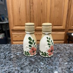Ceramic Vintage Floral Design pair of salt and pepper shakers. Size approximately 3 3/4 inches tall. Preowned . Has been on display in a cabinet