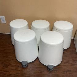5 small white trash cans