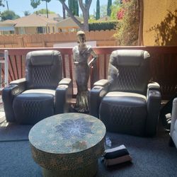 Dark Gray leather couches.
 Reclinable. With cupholders