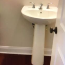 White Porcelain pedestal sink.   
