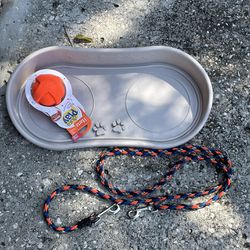 Dog leash and Food/Water tray like new and dog toy.