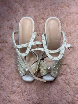 White pearl embellished heels with gold accents