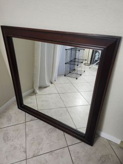 48 in by 48 in hanging wall mirror with a 4-in Wooden Frame $45.-  Firm