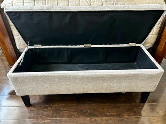 Beige upholstered storage bench